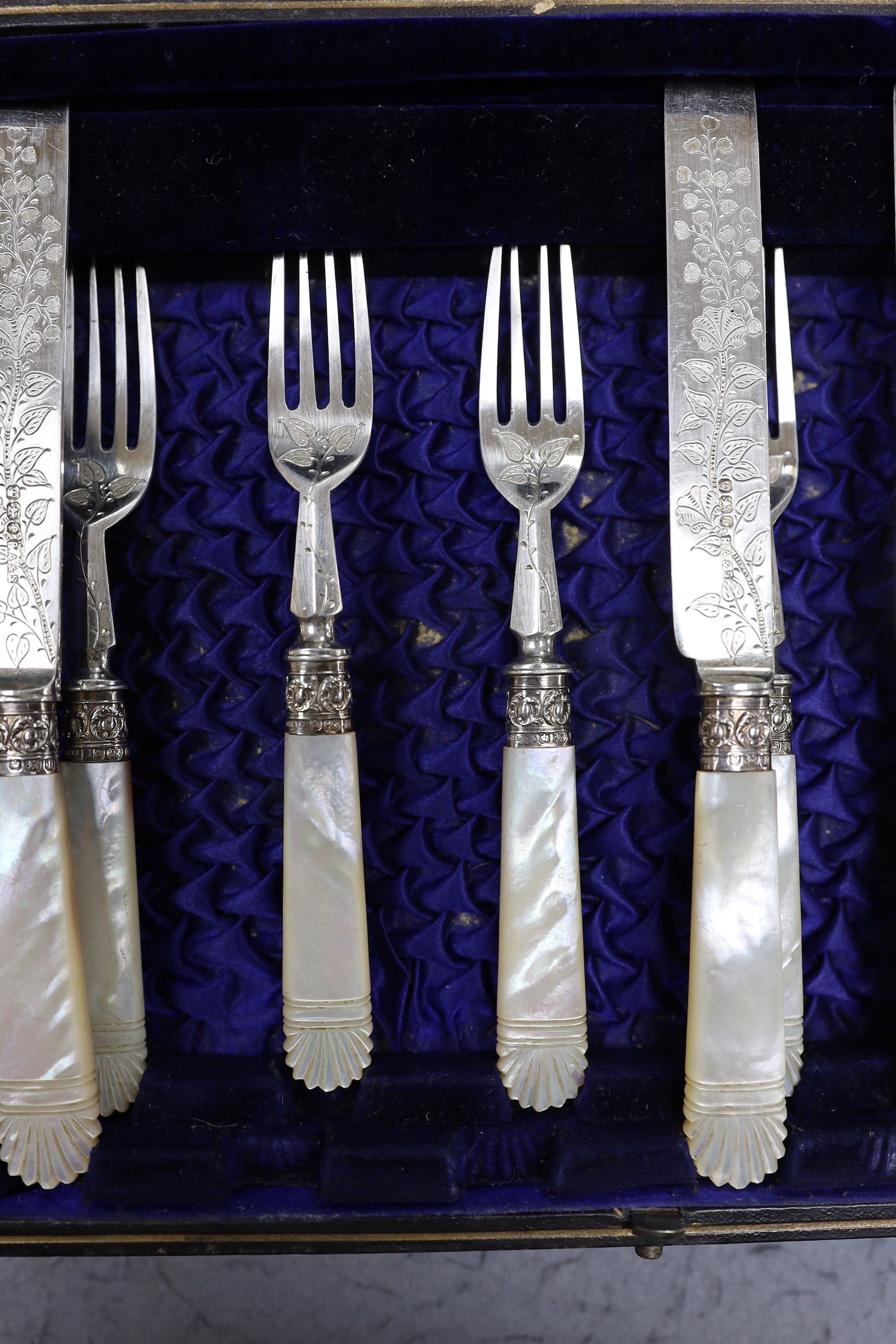 A cased set of six pairs of late Victorian mother of pearl handled silver dessert eaters, P. Ashberry & Sons, Sheffield, 1895.